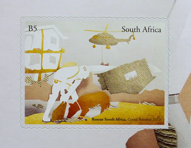 The first stamp at full size. A white cutout figure works at the rubble of a collapsed house while a corrugated-card helicopter lifts a load overhead, everything built from torn paper in white, ochre and gold.