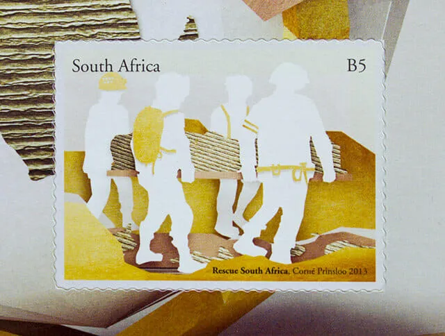 The second stamp at full size. Four white cutout rescuers in silhouette carry a corrugated-card stretcher across an ochre paper landscape, one wearing a yellow pack, one carrying a torch.